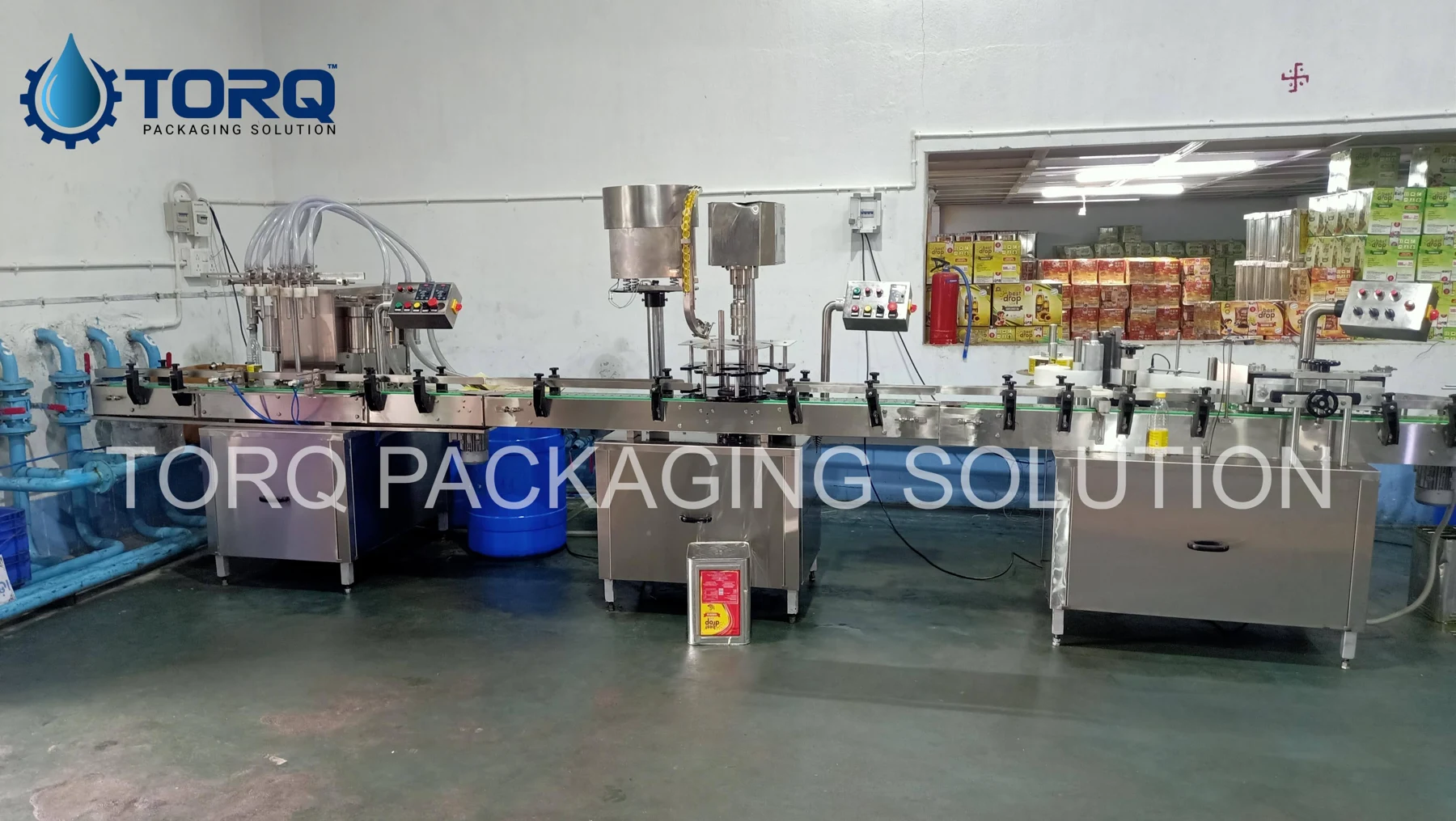 Four-head filling, capping and labelling line