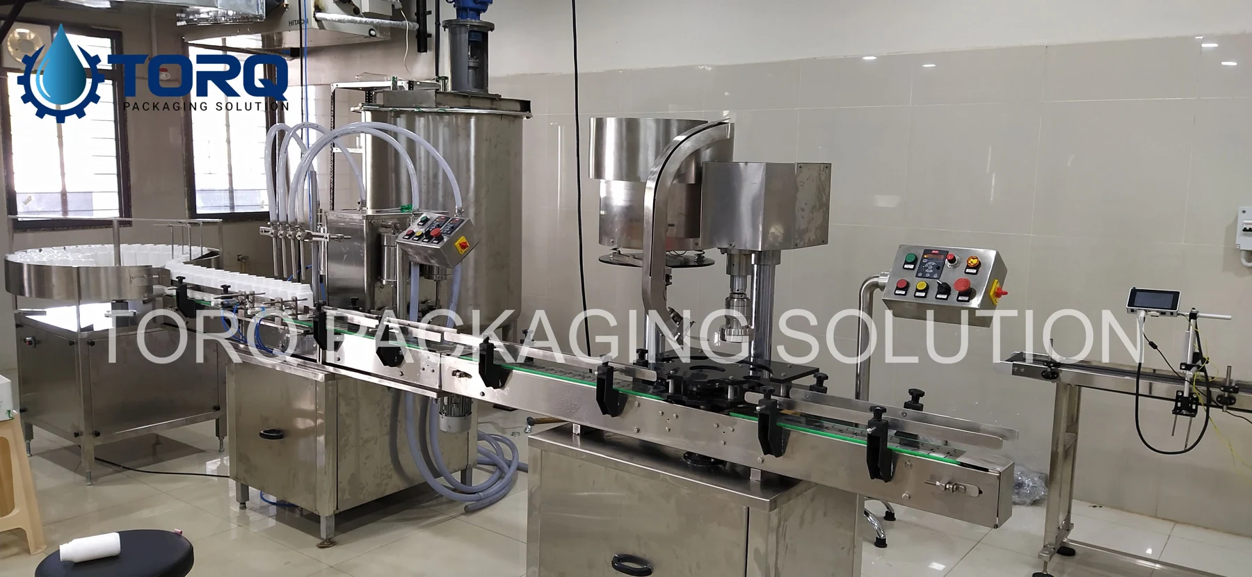 Four-head filling and capping line, view 2
