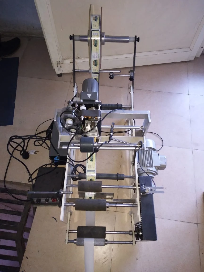 Compact conveyor filling machine — workshop view